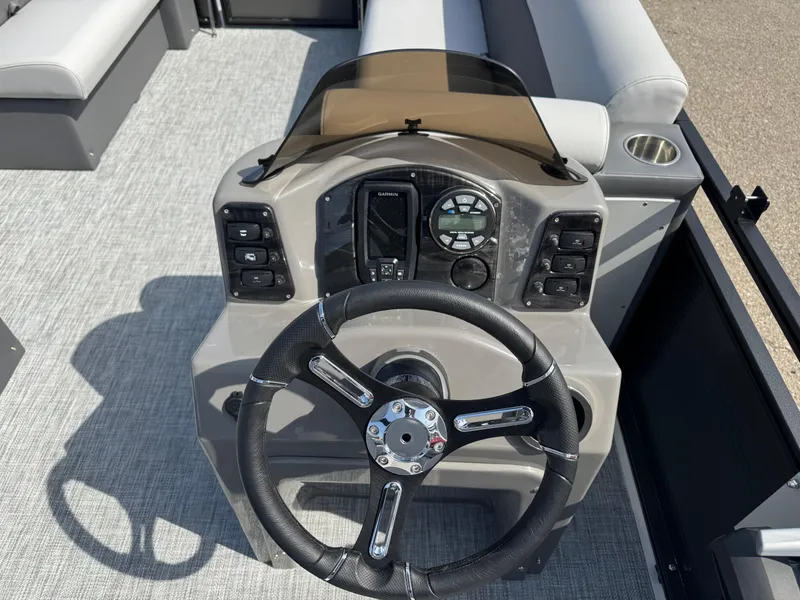 Slide: The Image of 2025 Qwest E 20 Lanai boat dashboard with steering wheel and control panel. - 18