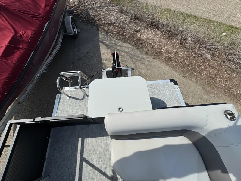 Slide: The Image of 2025 Qwest E 20 Lanai boat interior with seating and control panel, viewed from above. - 20
