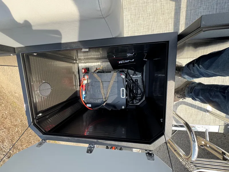 Slide: The Image of Battery compartment of 2025 Qwest E 20 Lanai boat, showing secured battery and wiring. - 21