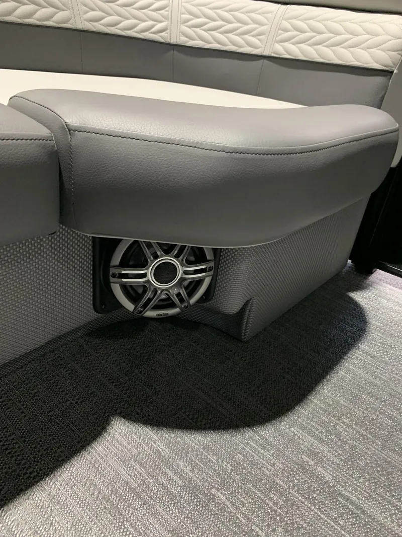 Slide: The Image of 2025 Godfrey Monaco 235 SD boat interior with speaker and cushioned seating. - 5