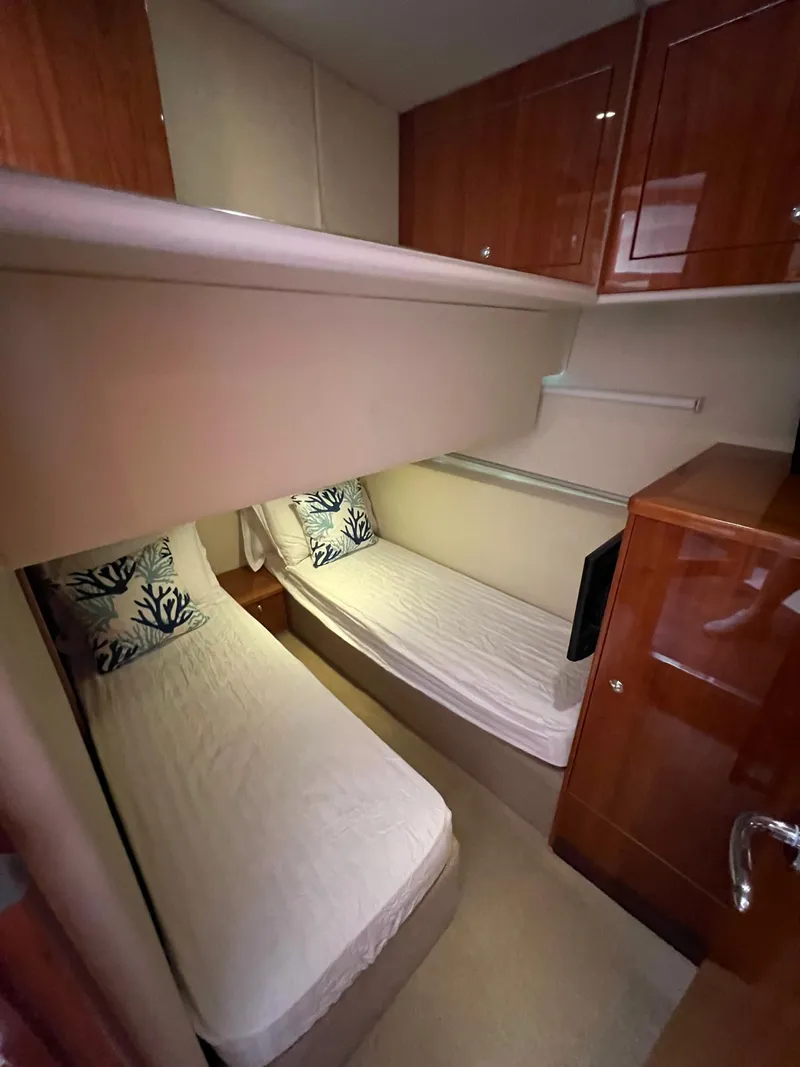 Slide: The Image of 2016 Riviera 45 Open Flybridge cabin with twin beds and wooden cabinetry. - 14