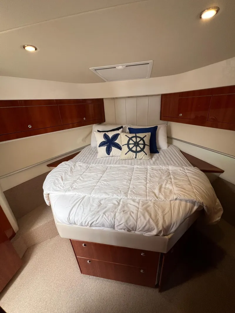 Slide: The Image of Luxurious bedroom in 2016 Riviera 45 Open Flybridge yacht with nautical-themed decor. - 17