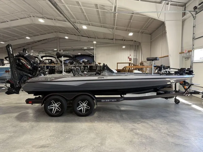 Slide: The Image of 2025 Skeeter ZXR20 boat in showroom, side view, on trailer. - 1