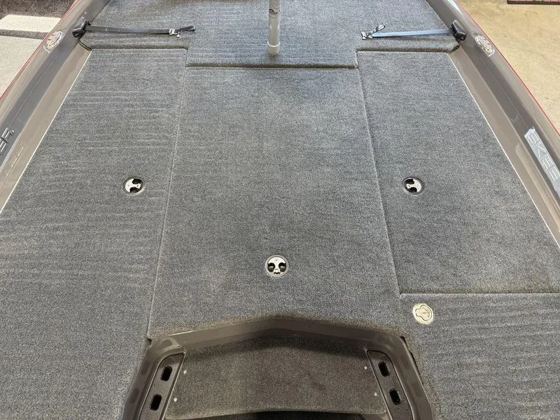 Slide: The Image of 2025 Skeeter ZXR20 boat deck with gray carpet and storage compartments. - 10