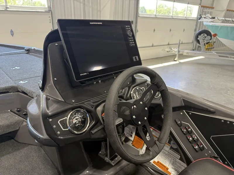 Slide: The Image of 2025 Skeeter ZXR20 boat dashboard with steering wheel and Humminbird Xplore 12 display. - 13