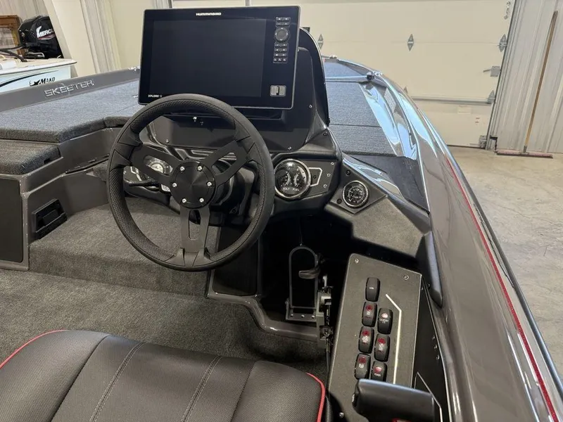 Slide: The Image of 2025 Skeeter ZXR20 boat cockpit with steering wheel and advanced navigation display. - 17
