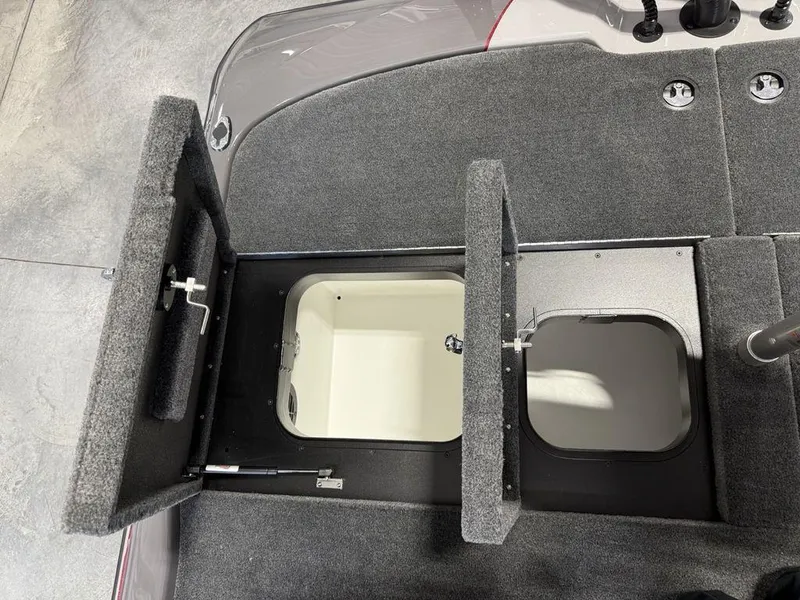 Slide: The Image of 2025 Skeeter ZXR20 boat storage compartments with open hatches, showcasing interior design. - 18