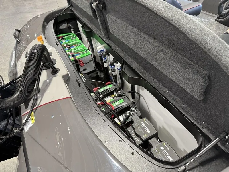Slide: The Image of 2025 Skeeter ZXR20 boat battery compartment with multiple batteries and wiring. - 19