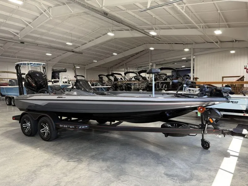 Slide: The Image of 2025 Skeeter ZXR20 boat in showroom, sleek design, dual axle trailer. - 6
