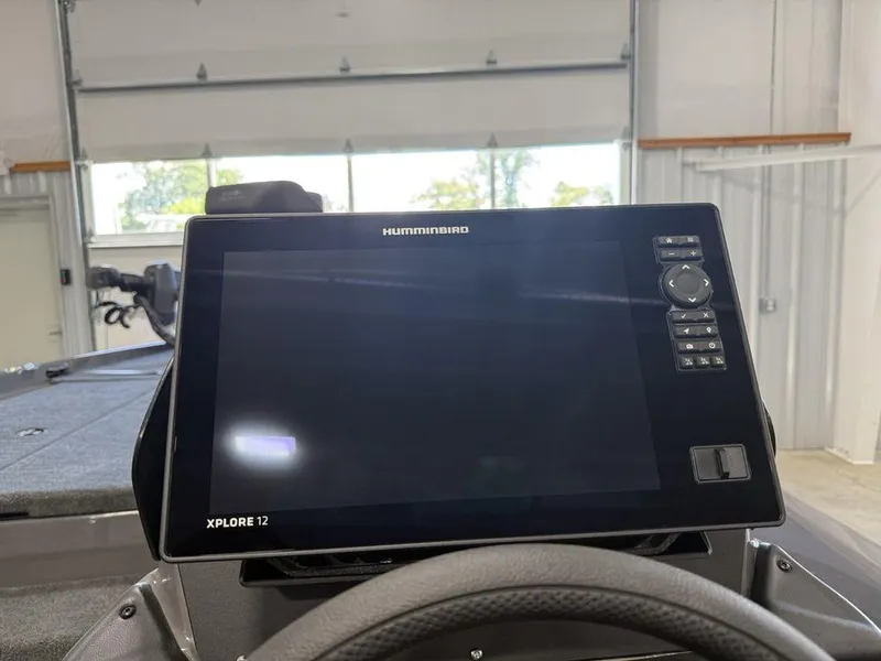 Slide: The Image of 2025 Skeeter ZXR20 boat with Humminbird Xplore 12 display in a garage setting. - 9