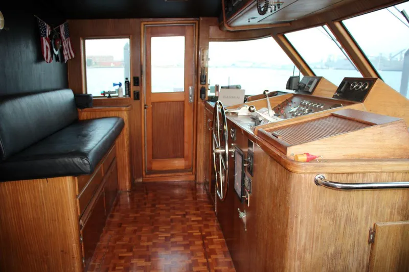 Slide: The Image of 1985 Hatteras 72 Motor Yacht helm with wooden interior and navigation equipment. - 12