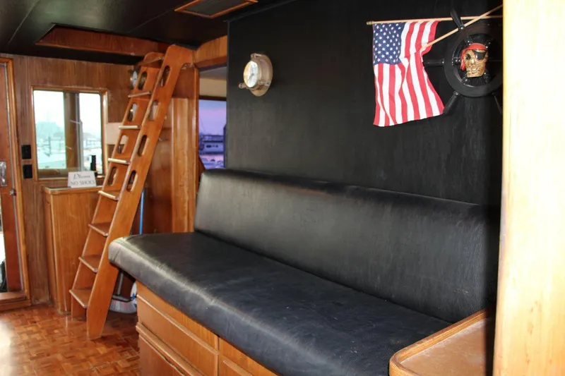 Slide: The Image of Interior of 1985 Hatteras 72 Motor Yacht with wooden ladder and American flag decor. - 13