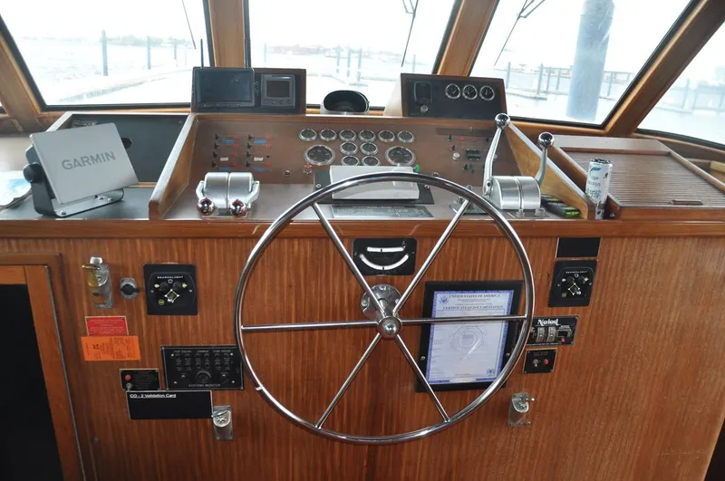 Slide: The Image of Helm of 1985 Hatteras 72 Motor Yacht with navigation equipment and wooden dashboard. - 14