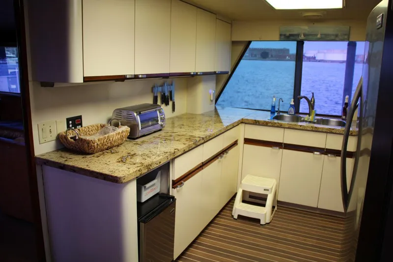 Slide: The Image of Kitchen interior of 1985 Hatteras 72 Motor Yacht with granite countertops and ocean view. - 19