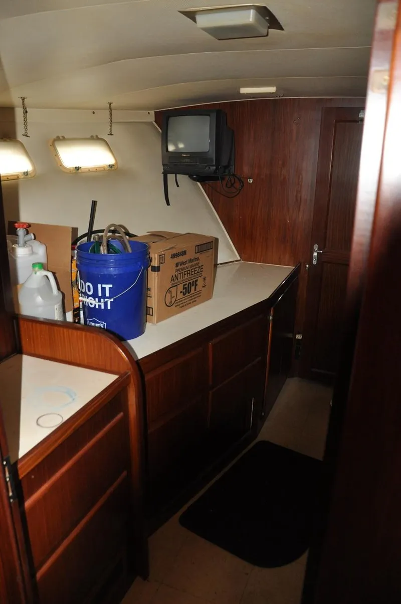 Slide: The Image of 1985 Hatteras 72 Motor Yacht interior with wood cabinetry and storage items. - 22