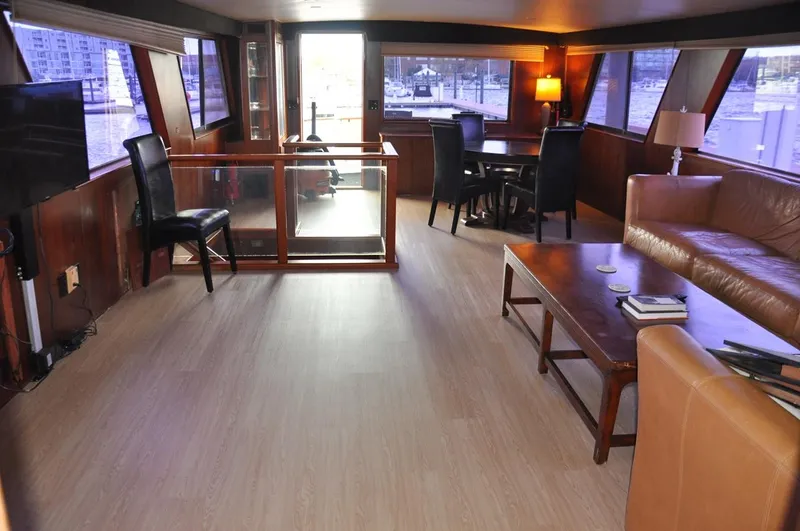 Slide: The Image of Luxurious interior of 1985 Hatteras 72 Motor Yacht with elegant seating and dining area. - 26