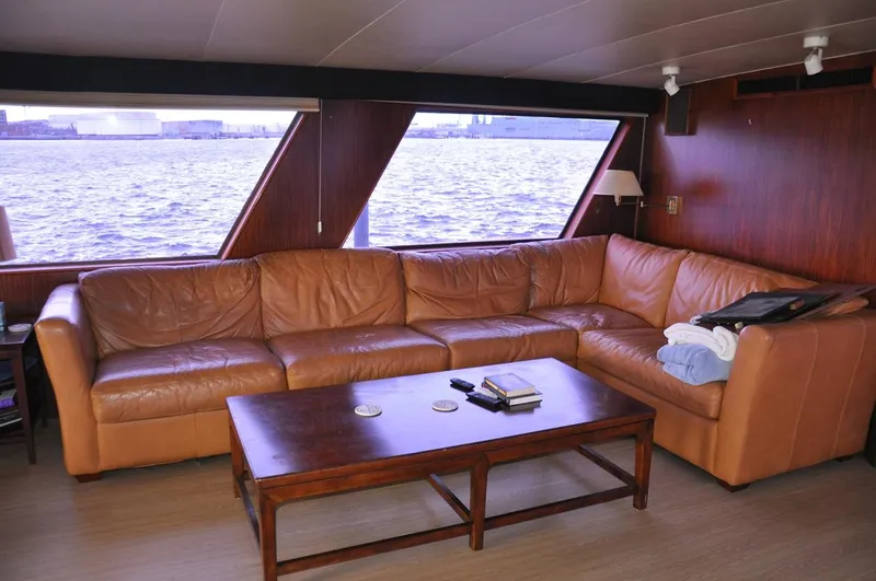Slide: The Image of Luxurious leather seating in 1985 Hatteras 72 Motor Yacht interior with waterfront view. - 27