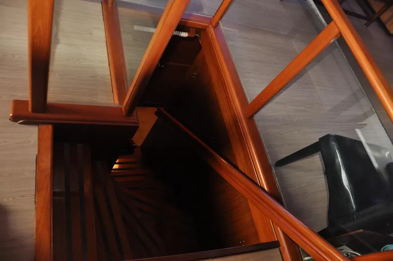 Slide: The Image of Wooden staircase inside 1985 Hatteras 72 Motor Yacht, featuring elegant design and craftsmanship. - 33