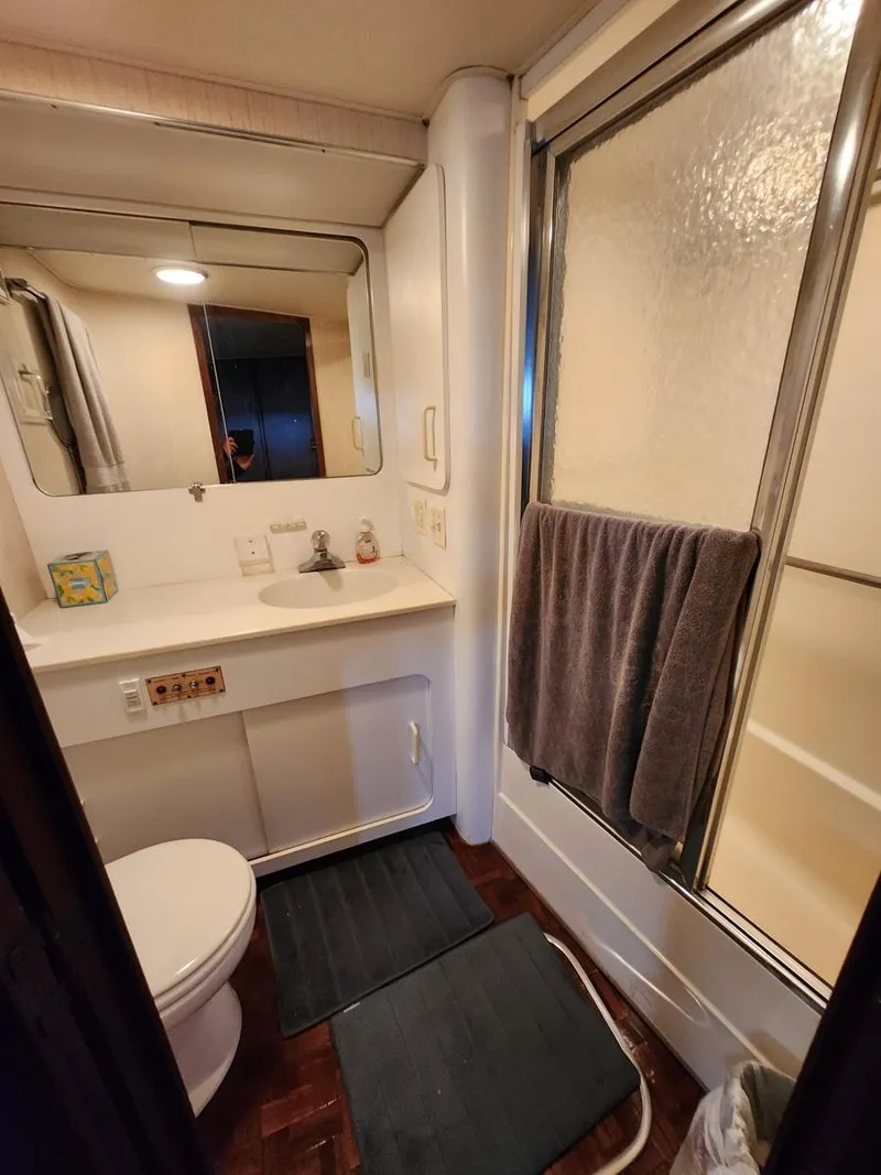 Slide: The Image of 1985 Hatteras 72 Motor Yacht bathroom with shower, sink, and toilet. - 42
