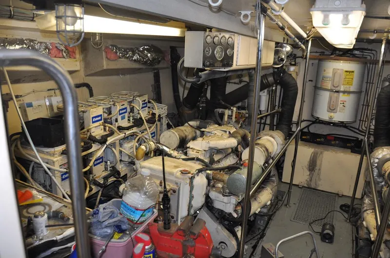 Slide: The Image of Engine room of a 1985 Hatteras 72 Motor Yacht, showcasing machinery and equipment. - 44