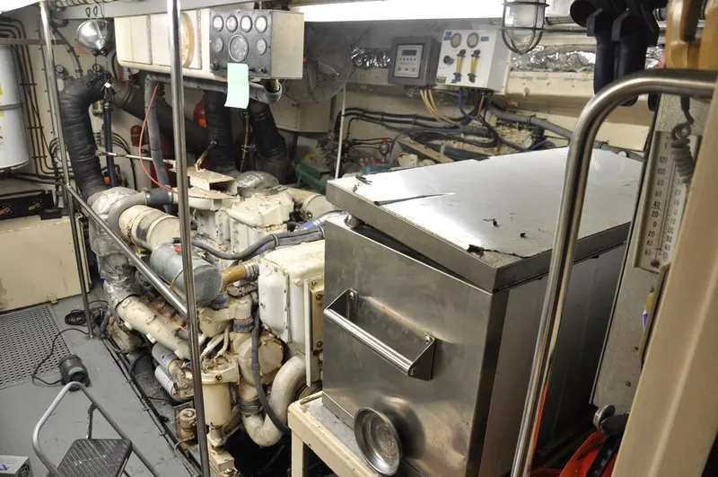 Slide: The Image of Engine room of 1985 Hatteras 72 Motor Yacht with machinery and control panels. - 45