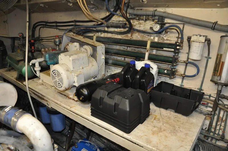 Slide: The Image of Engine room of 1985 Hatteras 72 Motor Yacht with equipment and maintenance supplies. - 48