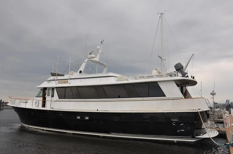 Slide: The Image of 1985 Hatteras 72 Motor Yacht docked under cloudy skies. - 5