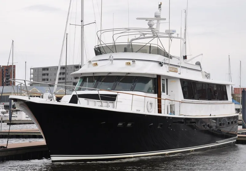 Slide: The Image of 1985 Hatteras 72 Motor Yacht docked at marina, showcasing sleek design and classic elegance. - 6