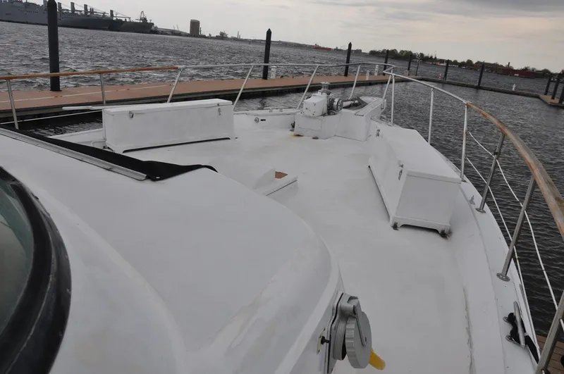 Slide: The Image of 1985 Hatteras 72 Motor Yacht deck view at marina, overcast sky. - 7