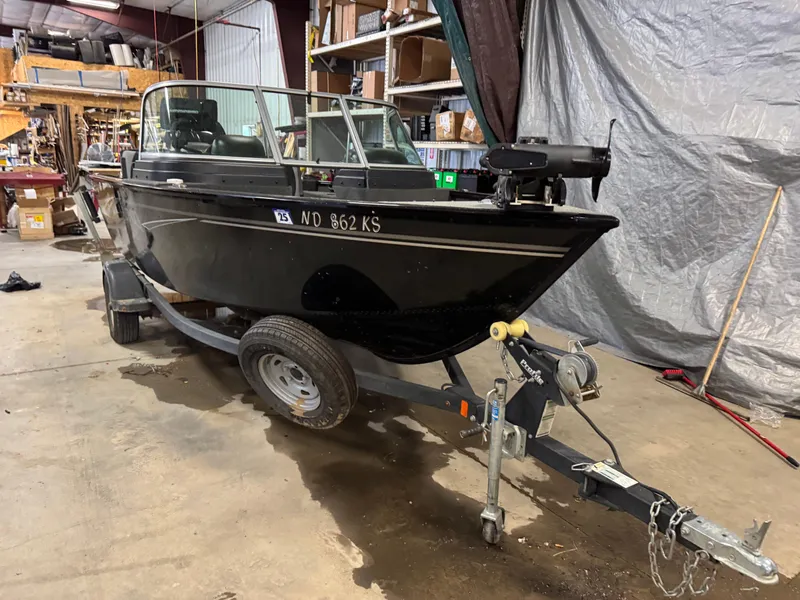 Slide: The Image of 2019 Lund 1675 Adventure Sport boat on trailer in a garage setting. - 0