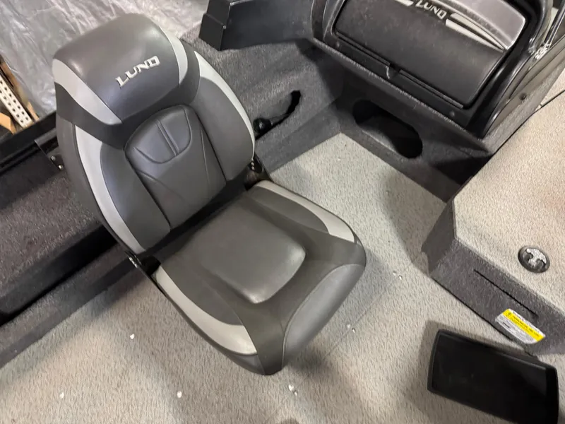 Slide: The Image of 2019 Lund 1675 Adventure Sport boat seat, gray and black design, interior view. - 10