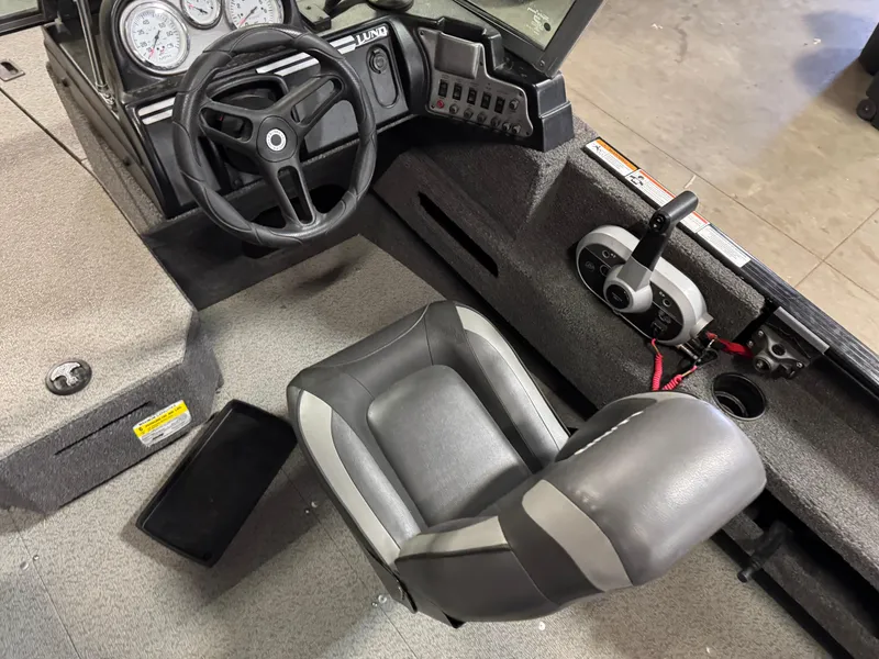 Slide: The Image of 2019 Lund 1675 Adventure Sport boat interior with steering wheel and seat. - 12