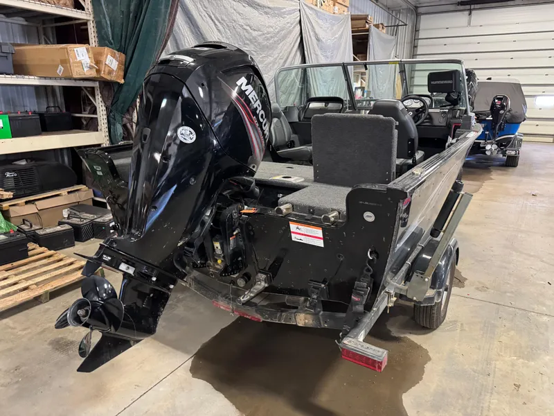 Slide: The Image of 2019 Lund 1675 Adventure Sport boat with Mercury outboard motor in a garage. - 2