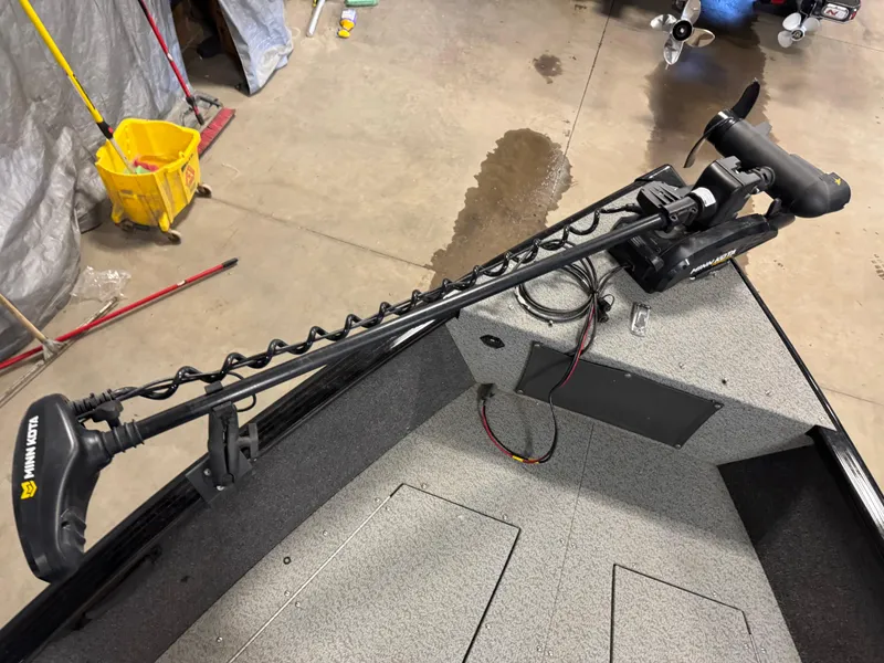 Slide: The Image of 2019 Lund 1675 Adventure Sport boat with trolling motor in a garage setting. - 4