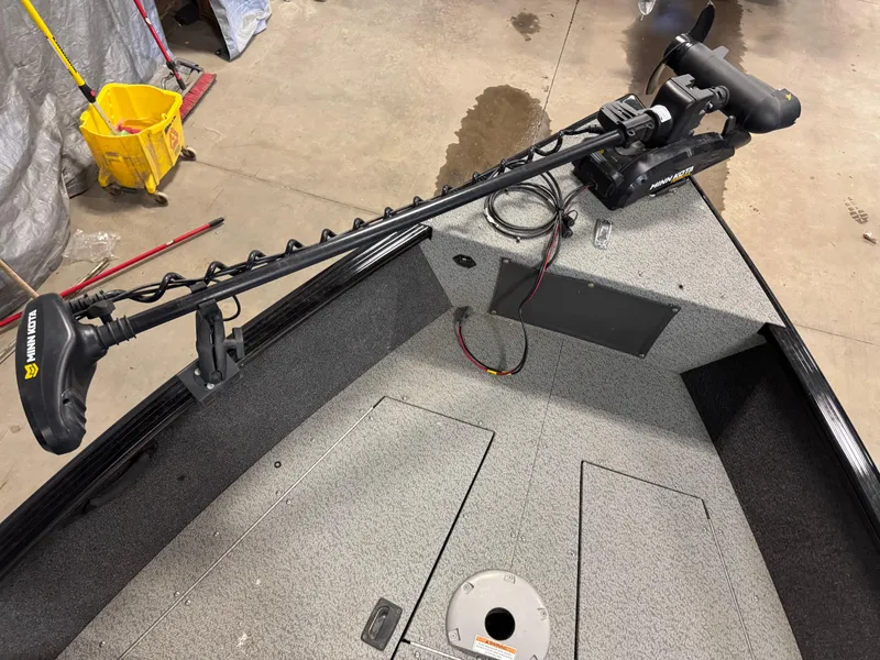 Slide: The Image of 2019 Lund 1675 Adventure Sport boat with trolling motor in a garage setting. - 6