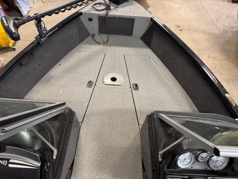 Slide: The Image of 2019 Lund 1675 Adventure Sport boat interior with gray deck and control panel. - 7