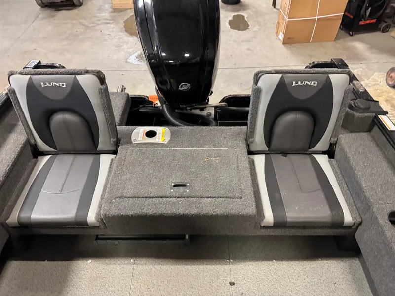 Slide: The Image of 2019 Lund 1675 Adventure Sport boat interior with dual seats and motor. - 9