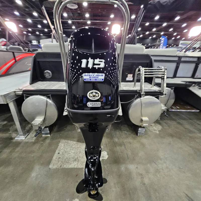 Slide: The Image of 2025 Qwest L 22RLS boat with 115 horsepower engine displayed indoors. - 12