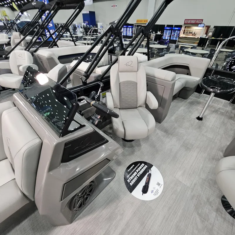 Slide: The Image of 2025 Qwest L 22RLS boat interior with modern seating and control panel. - 7