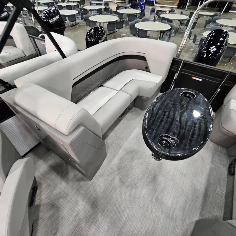 Slide: The Image of 2025 Qwest L 22RLS boat interior with gray seating and sleek black table. - 9