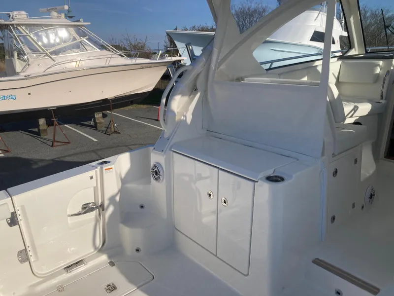 Slide: The Image of 2025 Pursuit OS 325 boat interior with sleek white design and storage compartments. - 10