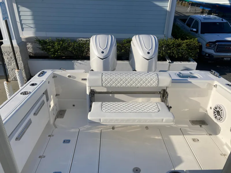 Slide: The Image of 2025 Pursuit OS 325 boat with dual engines and cushioned seating in a marina setting. - 12