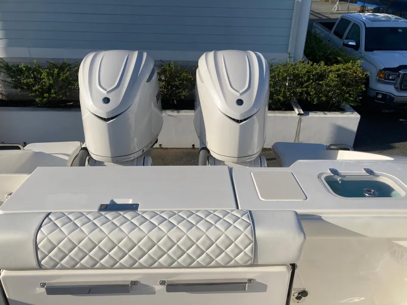 Slide: The Image of 2025 Pursuit OS 325 boat with dual engines and quilted seating. - 13