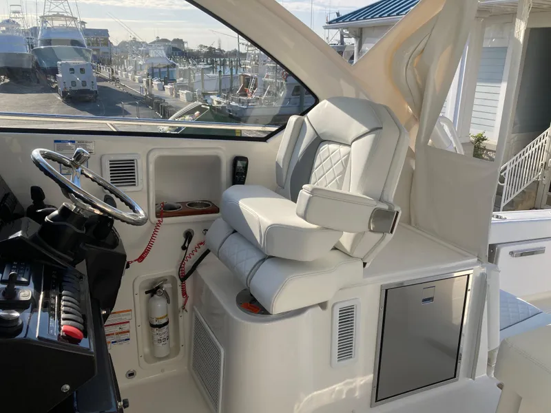Slide: The Image of 2025 Pursuit OS 325 helm with luxurious seating and modern controls. - 22
