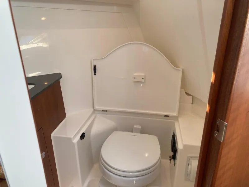Slide: The Image of 2025 Pursuit OS 325 boat bathroom with compact toilet and sleek design. - 33