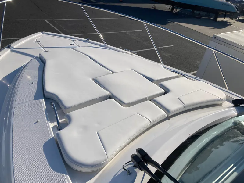 Slide: The Image of 2025 Pursuit OS 325 boat with white cushioned deck seating. - 39