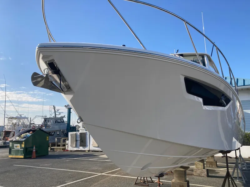 Slide: The Image of 2025 Pursuit OS 325 boat on display in a marina setting. - 4