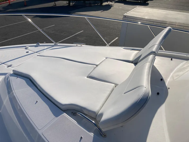 Slide: The Image of 2025 Pursuit OS 325 boat with white cushioned sunbed on deck. - 41