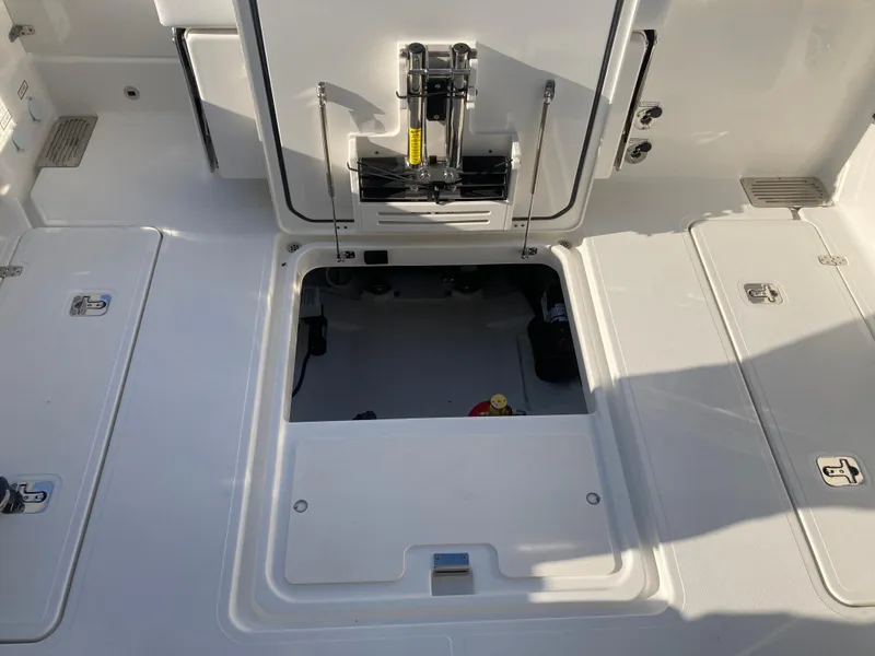 Slide: The Image of 2025 Pursuit OS 325 boat deck with open storage compartment. - 42