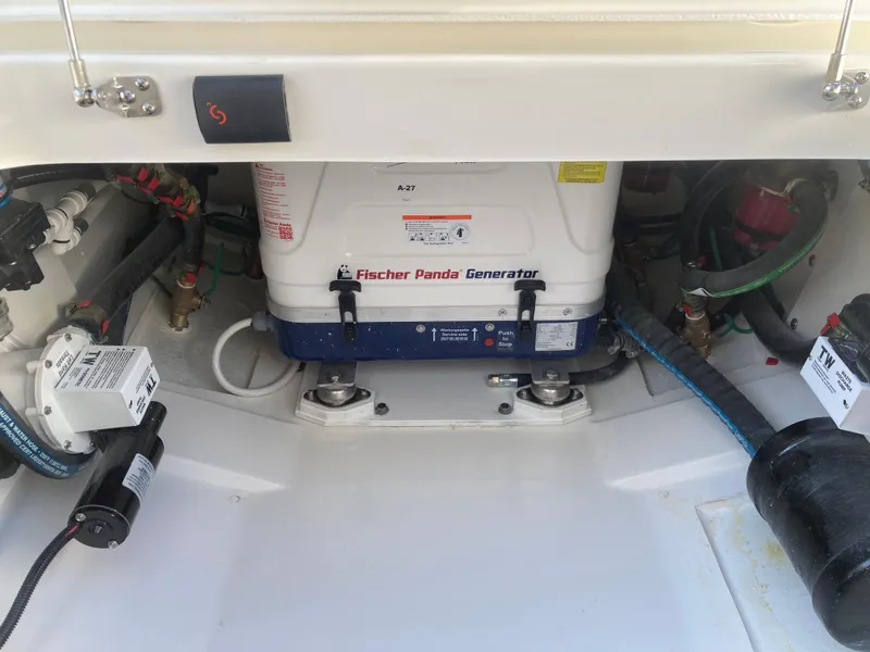Slide: The Image of Fischer Panda generator in a 2025 Pursuit OS 325 boat engine compartment. - 43